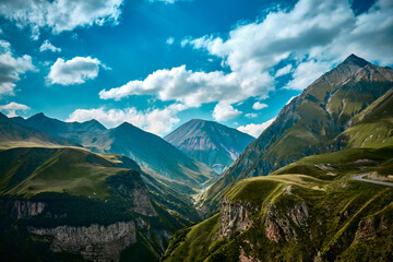 Mountain ranges on a sunny day at Georgia. Sky with clouds adn hills