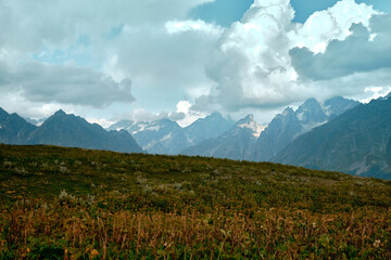 Fototapeta premium Mountain ranges on a sunny day at Georgia. Sky with clouds adn hills