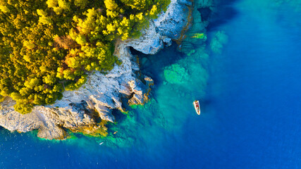 A sea bay. Clear turquoise water and a boat. View from the air. Summer landscape from a drone. Rest...