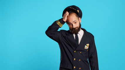 Airline captain raising shoulders and being unsure, shrugging and not knowing answer to question....