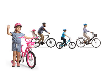 Fototapeta premium Family riding bicycles and a girl waving at camera