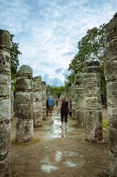 woman visiting the Temple of a Thousand Warriors at Chichen Itza, city of the new World seven wonders, mexico.
