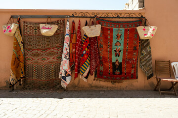 Traditional moroccan rugs and souvenirs in the walls of the Marrakech Medina streets in Morocco