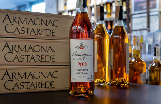Bottles of France Armagnac Castarede XO close-up on background of branded boxes. Ukraine, Zhytomyr, May, 22, 2023