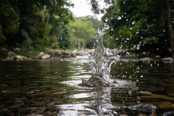 Fototapeta na wymiar Splash made with a stone falling into the water of the waterfall in Paraty in Rio de Janeiro