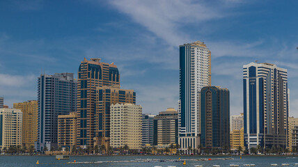 Fototapeta na wymiar Sharjah city view, high rise buildings with lagoon