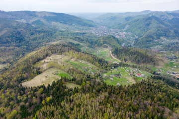 Fototapeta na wymiar An aerial view of the mountain Yaremche town from above, green Carpathian mountains