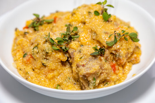 Traditional pork tenderloin recipe with corn grits and fresh marjoram (Origanum majorana). "Su&atilde;n com quirera".