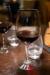 Dinner with glass of dry red wine in Italian osteria restaurant