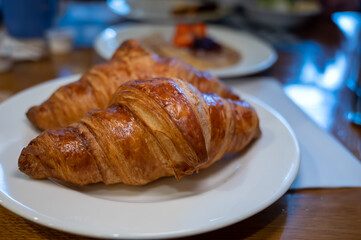 Two fresh baked puff croissants, traditional French breakfast