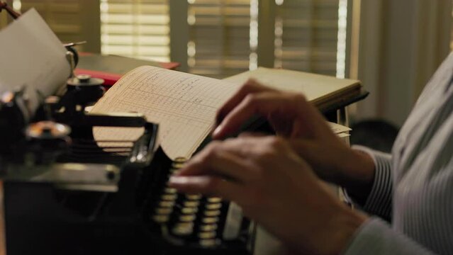 vintage 1910 woman writing in a ledger and using a typewriter
