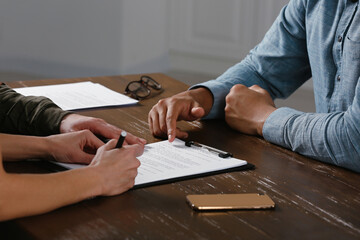 Notary working with couple at wooden table, closeup