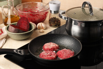 Cooking vegan cutlets in frying pan on stove