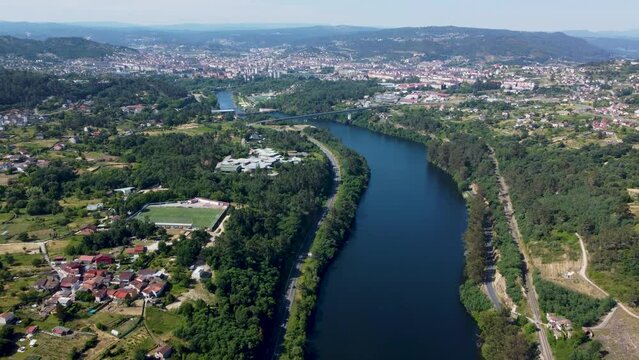 Aerial dolly along beautiful ourense river and town of velle, galicia, spain