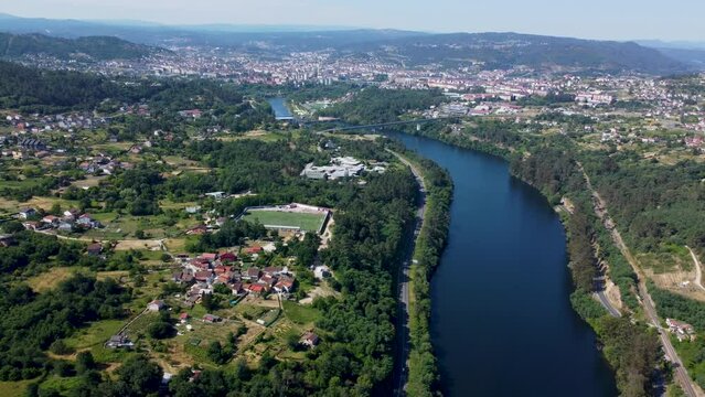 Mino river leading up to Ourense and Velle in Spain, aerial trucking pan panoramic