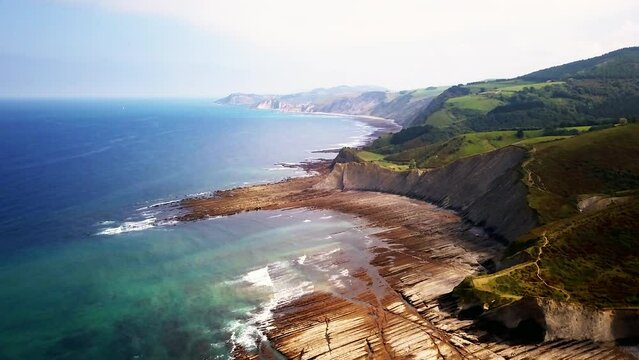 Aerial cinematic drone San Sebastian Basque Country Spain France Border rugged countryside coastline  Pyrenees mountain range ocean surf waves scenic view on Bay of Biscay backward motion