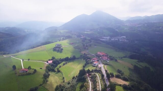 Aerial cinematic drone San Sebastian Basque Country Spain France Border rugged  countryside coastline green Pyrenees mountain range  burning trash scenic view of hills slowly down motion