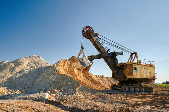 Shovel mining excavator operates in large open chalk quarry