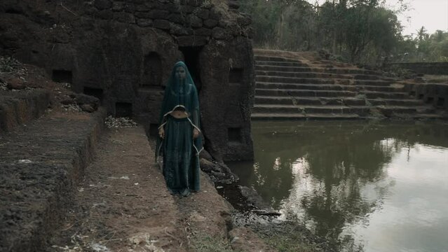 woman in veil, veiled girl appearance, spooky shot, black widow, India, static pose in traditional clothing. symbolic, cinematic.