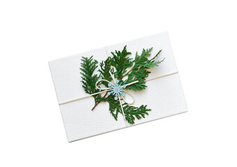 White gift box DIY decorated for Christmas with evergreen branch top down view isolated cutout on transparent