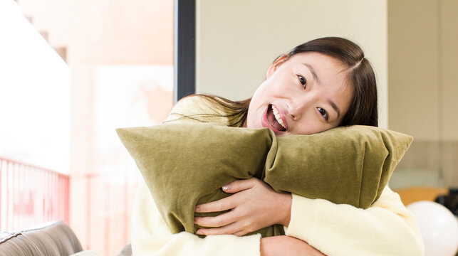asian pretty woman with a pillow and resting on a couch