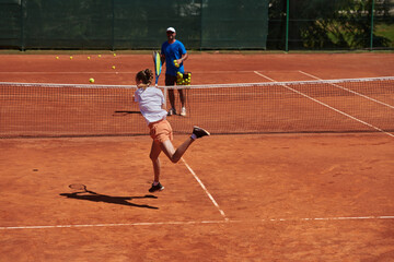 A professional tennis player and her coach training on a sunny day at the tennis court. Training and preparation of a professional tennis player