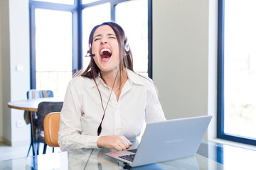 young pretty woman shouting aggressively, looking very angry. telemarketer concept