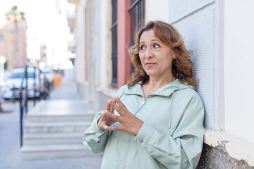 middle age woman scheming and conspiring, thinking devious tricks and cheats