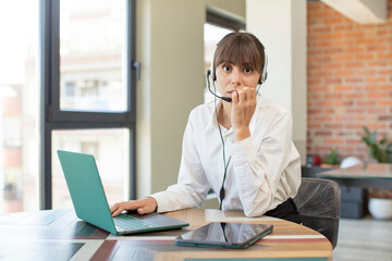 young pretty woman feeling scared, worried or angry and looking to the side. telemarketer concept