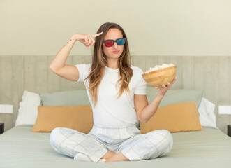 pretty woman looking surprised, realizing a new thought, idea or concept. popcorns and movie concept