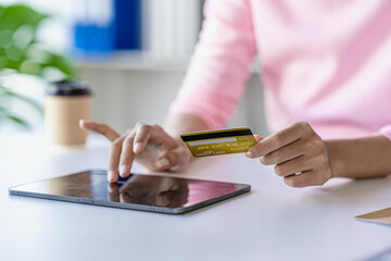 Woman shopping using tablet pc and credit card Woman shopping online with credit card. Pay online. Buy online. Pay by internet banking.