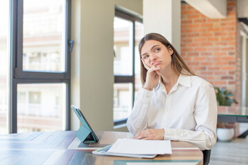 young pretty woman feeling bored, frustrated and sleepy after a tiresome. telecommuting concept