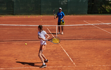 A professional tennis player and her coach training on a sunny day at the tennis court. Training and preparation of a professional tennis player