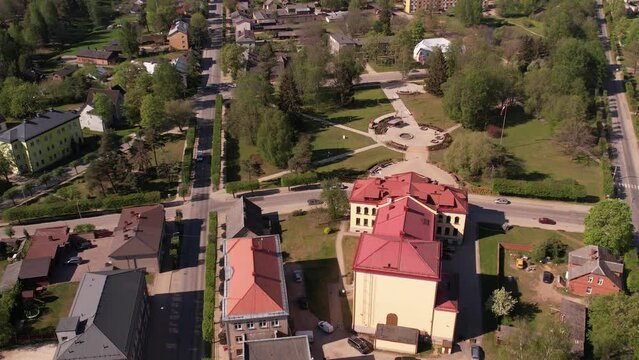A small border town in Latvia. Valka city at sunset. Drone flight over the city