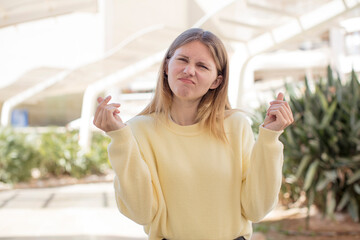 pretty young woman feeling sad and stressed, no money gesture, with a negative and anxious look