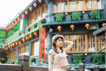Fototapeta woman traveler visiting in Taiwan, Tourist with hat sightseeing in Jiufen Old Street village with Tea House background. landmark and popular attractions near Taipei city . Travel and Vacation concept obraz