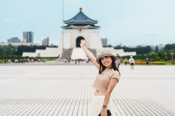 woman traveler visiting in Taiwan, Tourist with hat sightseeing in National Chiang Kai shek Memorial or Hall Freedom Square, Taipei City. landmark and popular attractions. Asia Travel concept - obrazy, fototapety, plakaty