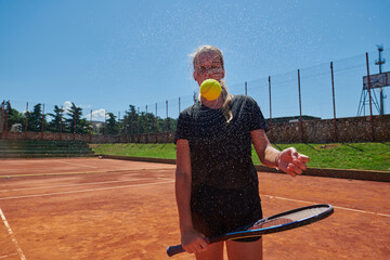 Before her training, the tennis player joyfully playing with a tennis ball, radiating enthusiasm...