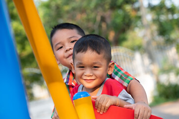 Fototapeta na wymiar Happy Asian Kids playing on playground 