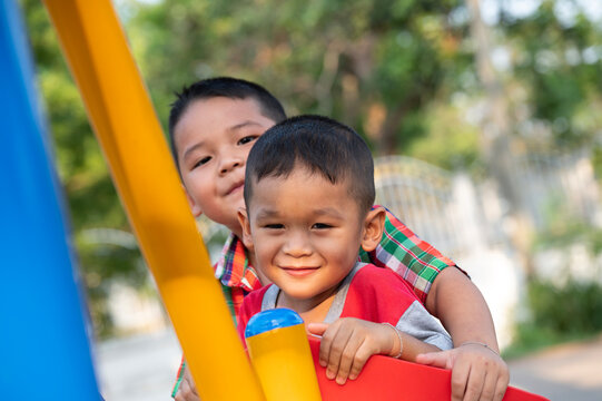 Happy Asian Kids Playing On Playground 