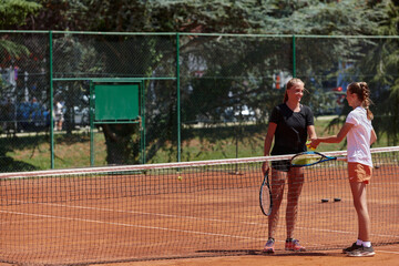 Tennis players standing together on the tennis court, poised and focused, preparing for the start of their match