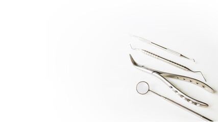 Fototapeta premium Dental mirror or instrument on white table with blur background and space.Tooth or teeth problem at dental clinic.Orthodontic and Dentistry concept.Dentist tool at clinic or hospital.Tooth extraction.