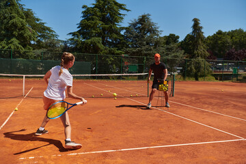 A professional tennis player and her coach training on a sunny day at the tennis court. Training and preparation of a professional tennis player