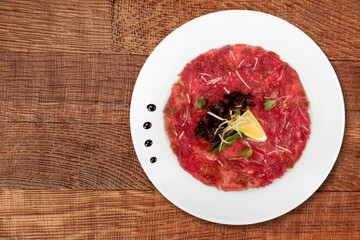 Flat slices of ham and meat with herbs.