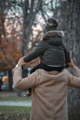 Dad carrying his son with great joy and luck to have him on Father's Day - obrazy, fototapety, plakaty