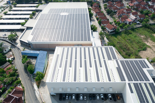Eco building, shopping center in aerial view. Solar cell or photovoltaic cell in panel on top of roof to generate electrical power or direct current electricity. Green, clean energy for future.