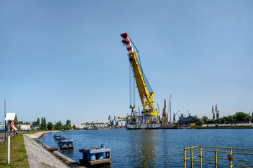 The world's largest ship, a crane for erecting windmills at sea, displacement 61,000, lifting capacity 5,000 tons, moored at the quay of Stocznia Remontowa, Gdansk, Poland - Les Alizés (IMO number 991 - obrazy, fototapety, plakaty