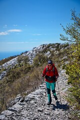 Senior woman hiking in karst landscape in Croatia