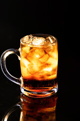 A cold drink in a glass filled with ice