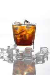 A cold drink in a glass filled with ice